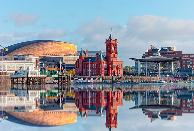 golygfa o Fae Caerdydd gydag adlewyrchiadau o adeiladau yn y dŵr